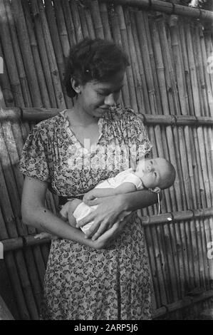 Portrait photos (miscellaneous) [passport photos]  Indonesian woman holding baby Date: 1947/01/01 Location: Indonesia, Dutch East Indies Stock Photo