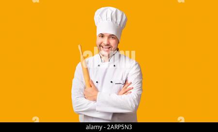 Chef Man Holding Rolling Pin Standing On Yellow Background, Panorama Stock Photo