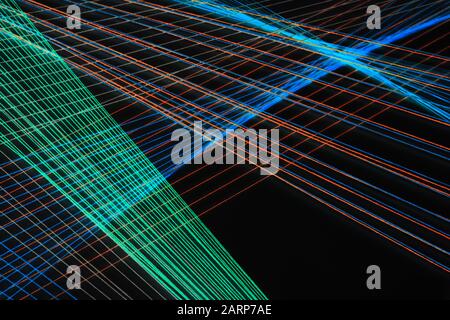 Abstract background photo with colorful treads over black wall, geometric pattern Stock Photo