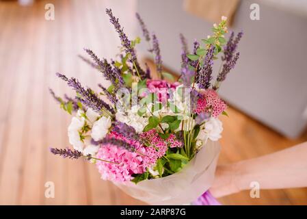 Bouquet of lavender and dry flowers. Colorful summer bunch of purple lavender and pink Hydrangea flowers. Stock Photo