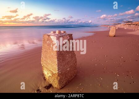 Sunset over the beach. Evening on the empty beach in Caesarea, Israel Stock Photo