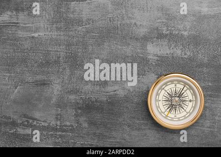 Golden navigational compass on a vintage gray background Stock Photo