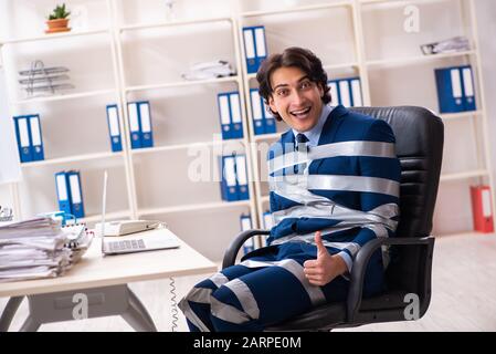 The young tied male employee in the office Stock Photo