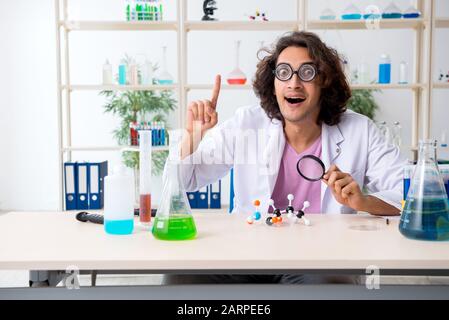 The funny male chemist working in the lab Stock Photo