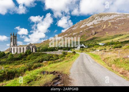 Country road leading towards the iconic Dalradian quartzite Mount Errigal with the ruined Dunlewy Church, Dunlewy, County Donegal, Ireland Stock Photo