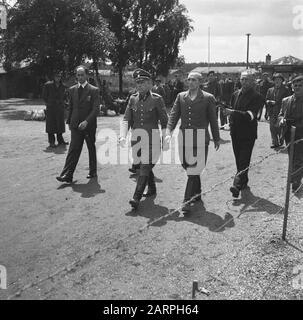Camp Amersfoort, internment camp for war criminals and collaborators  SS Kampguard B.J. Westerveld (right) and camp commander K.P. Berg guarded by men of the Domestic Armed Forces are by the camp led Date: 1945 Location: Amersfoort Keywords: prisoners, internment camps, war crimes, World War II Personal name: Berg, K.P., Westerveld, B.J. Stock Photo