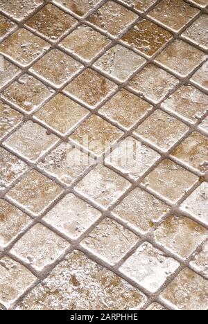 Close up of a new ceramic tile wall using various size tiles creating a natural background full of texture. Stock Photo