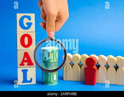 Wooden blocks with the word Goal and business team. Planning financial goals in a company. Business strategy. Cooperation and teamwork Stock Photo