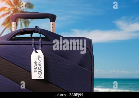 Blue suitcase with Travel Insurance label closeup Stock Photo