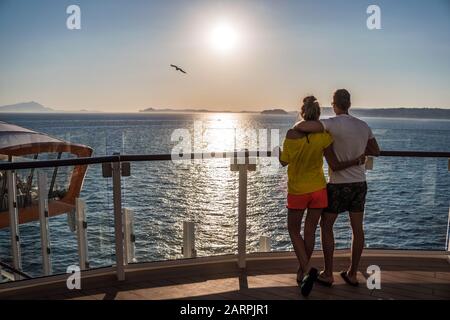 Cannes, France - July 4, 2019: Couple is watching sunset onboard newest cruise ship of Celebrity Cruises. Open deck and view on magic carpet on Edge. Stock Photo