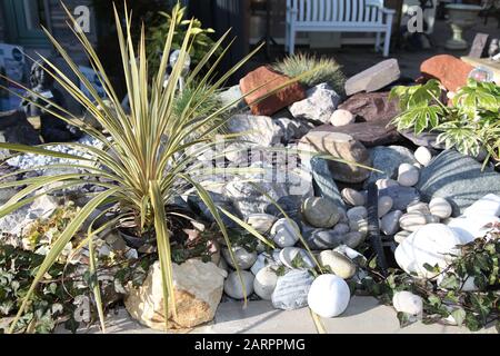 A show garden at Chessington Garden Centre with a Aztec grass and pebbles Stock Photo
