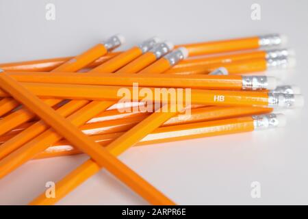 A pile of yellow HB pencils with eraser on endtip Stock Photo