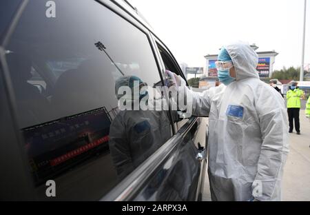 Hefei, China's Anhui Province. 29th Jan, 2020. A staff member measures temperatures of passengers at an expressway exit in Hefei, east China's Anhui Province, Jan. 29, 2020. Various measures are taken across China to combat the novel coronavirus. Credit: Liu Junxi/Xinhua/Alamy Live News Stock Photo