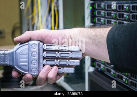 Handshake of man and robot. The concept of friendship between man and machine. The hand of the person and the robot on the background of the servent r Stock Photo