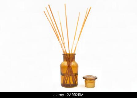 reed diffuser incense sticks with cap in glass bottle isolated on white backgroun Stock Photo