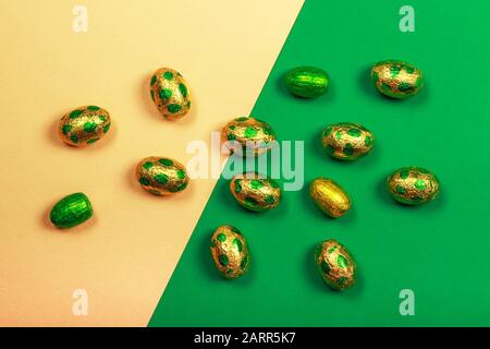Chocolate easter eggs wrapped in yellow and green colored foil. Stock Photo