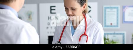 Female doctor hold silver pen in hand against Stock Photo