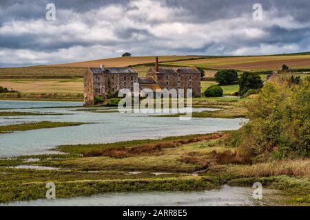Bretagne, north of France. An old abandoned factory near the city of Saint Malo in the middle of the green countryside and a swamp. Stock Photo