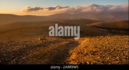 mountain road in the middle of the island of Fuerteventura at sunrise Stock Photo