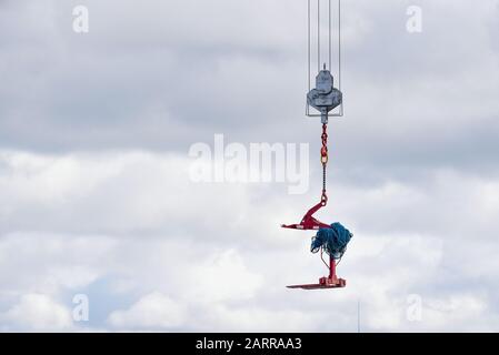 Crane hook hanging over an empty sky suspended in mid air Stock Photo