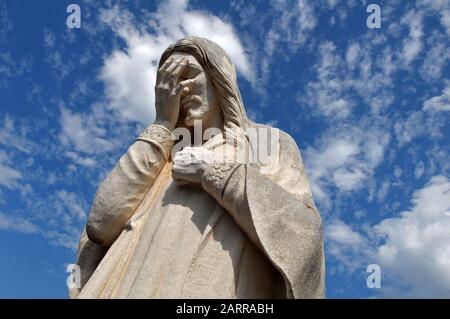 The statue 'And Jesus Wept', outside St. Joseph Old Cathedral and across from the site of the 1995 Oklahoma City bombing, pays tribute to those lost. Stock Photo