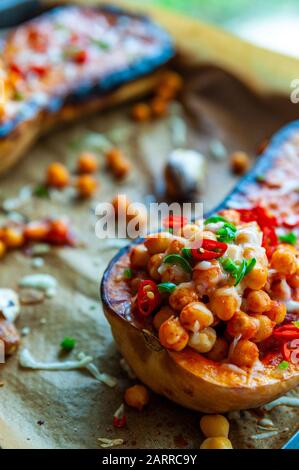 Roasted butternut squash topped with chickpea, pepper and cheese Stock Photo