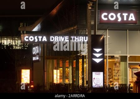 Costa Coffee drive thru and coffee shop lit up at night Stock Photo