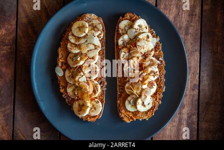 Overhead shot of a slices of bread topped with peanut butter, honey and banana slices Stock Photo