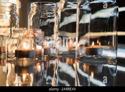 Votive candles in glass jars Stock Photo