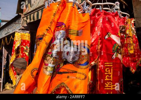 India, Rajasthan, Shekhawati, Nawalgarh, Nagar Palika market, colourful religious flag for sale decorated with image of Hindu Deity Krishna Stock Photo