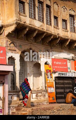 India, Rajasthan, Shekhawati, Nawalgarh, Kothi Road, woman at old privately owned haveli entrance Stock Photo