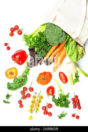 Zero waste heatlhy shopping concept. Vegetables flying out of the reusable cotton bag on white, top view, selective focus Stock Photo