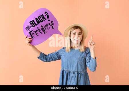 Beautiful woman holding speech bubble with text BLACK FRIDAY on color background Stock Photo