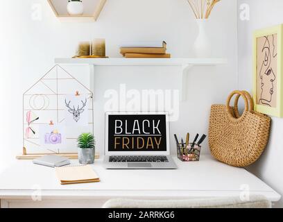 Black Friday advertising on screen of laptop on workplace Stock Photo