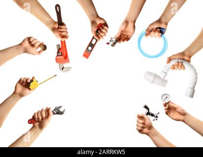Hands with different plumber tools on white background Stock Photo