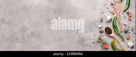 Different spices on grey background with space for text Stock Photo