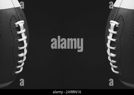 Black and white photo of rugby balls on dark background with space for text Stock Photo