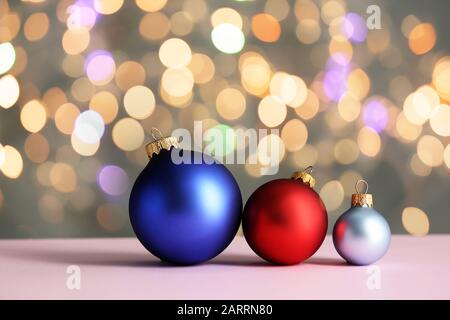 Beautiful Christmas balls on table against blurred lights Stock Photo
