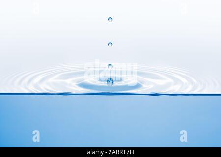 Cross section of ripple created by several drops, water underneath, copy space Stock Photo