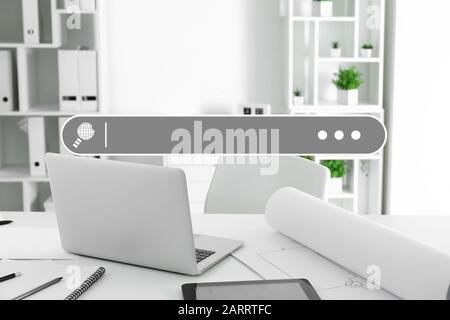 Laptop with search field on table in office Stock Photo