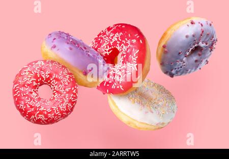 Sweet flying donuts on color background Stock Photo