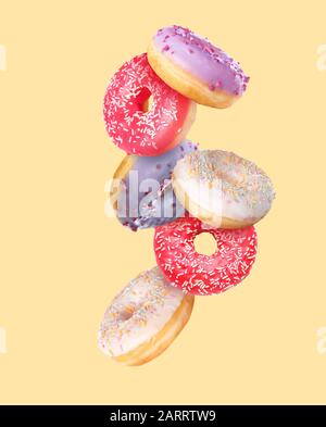 Sweet flying donuts on color background Stock Photo