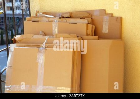 Paper pile and piece of cardboard prepared processing for industry paper plant. Cardboard is bundled into bales. Sunny day. Stock Photo
