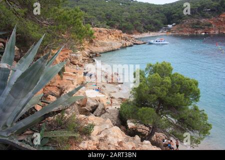 A cruise holiday on the sea in front of the cliffs and the most beautiful beaches of Ibiza in particular cala salada and cala saladeta in balearic isl Stock Photo