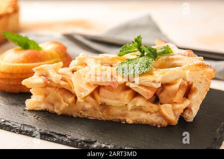 Piece of tasty apple pie on slate plate Stock Photo