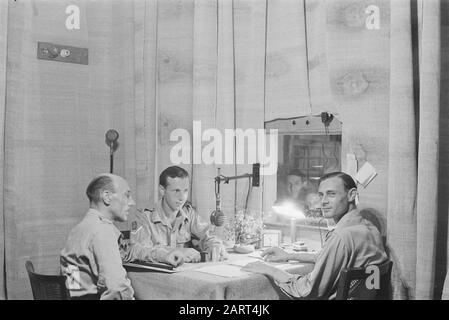 1000th greeting to the Netherlands from the studio in Semarang  Soldier G. van Poppel from 6-11 R.I. could do the thousandth greeting. On the left, the presenter Captain Branse. Date: 26 June 1947 Location: Indonesia, Java, Dutch East Indies, Semarang Stock Photo