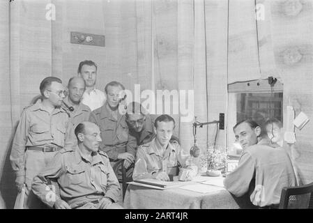 1000th greeting to the Netherlands from the studio in Semarang  Soldier G. van Poppel from 6-11 R.I. could do the thousandth greeting. To the left of him the presenter Captain Branse. Date: 30 June 1947 Location: Indonesia, Java, Dutch East Indies, Semarang Stock Photo