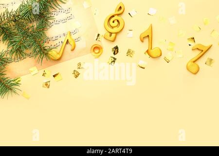 Note sheets and Christmas decor on color background Stock Photo