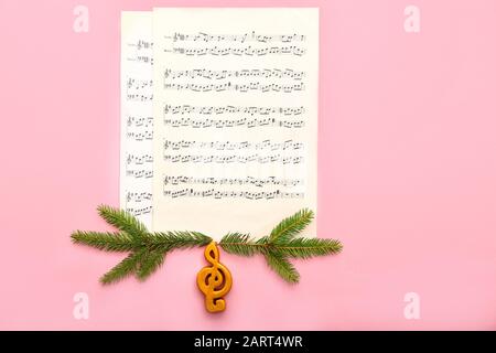 Note sheets and Christmas decor on color background Stock Photo