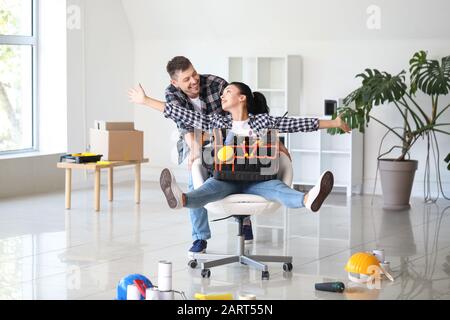 Happy couple having fun during repair in their new house Stock Photo